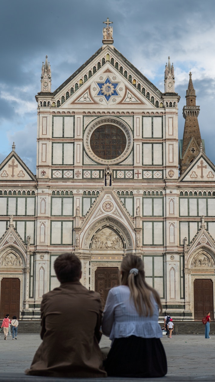 People look up at the Basilica di Santa Croce, Florence.
